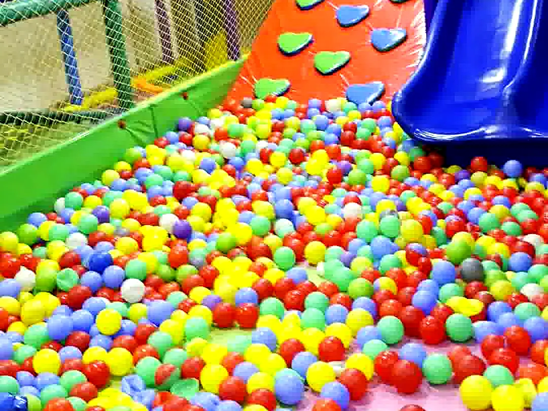Colourful ball pit with a blue slide and climbing wall at Yey Kidzarea