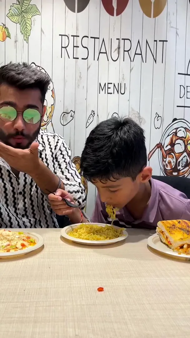 Father and son enjoying a meal together at the Yey Kidzarea café
