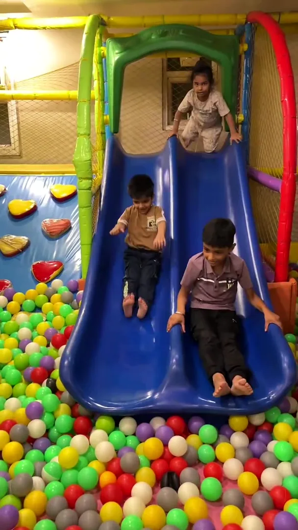 Child sliding down into the colourful ball pit at Yey Kidzarea